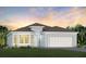Two-story house with a two-car garage and landscaping at 1104 Western Blue Way, Minneola, FL 34715