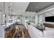 Open living room and kitchen with hardwood floors at 1104 Western Blue Way, Minneola, FL 34715