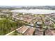 Aerial view of house and surrounding neighborhood by lake at 11637 Meadow Grove Cir, Orlando, FL 32836