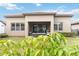 Home's backyard with covered patio and lush landscaping at 11637 Meadow Grove Cir, Orlando, FL 32836
