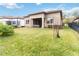 Large backyard with grassy area and play equipment at 11637 Meadow Grove Cir, Orlando, FL 32836
