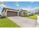 House exterior featuring a brick paver driveway and pergola at 11637 Meadow Grove Cir, Orlando, FL 32836