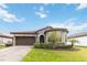 One-story house with a brick driveway and well-manicured lawn at 11637 Meadow Grove Cir, Orlando, FL 32836