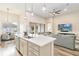 Island kitchen with white cabinets, quartz counters and stainless steel appliances at 11637 Meadow Grove Cir, Orlando, FL 32836