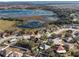 Aerial view of homes in a neighborhood by a lake at 1311 Plover Ct, Groveland, FL 34736