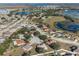 Aerial view of a residential neighborhood with houses and a lake at 1311 Plover Ct, Groveland, FL 34736