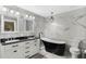 Bathroom featuring a freestanding tub, double vanity, and shower at 1311 Plover Ct, Groveland, FL 34736