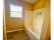 Clean bathroom with a bathtub and wood-look flooring at 152 Dakota Ave, Groveland, FL 34736