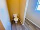 Small bathroom with toilet and wood-look flooring at 152 Dakota Ave, Groveland, FL 34736