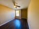 Well-lit bedroom featuring wood-look flooring and a window at 152 Dakota Ave, Groveland, FL 34736