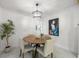 Bright dining room with round wooden table and four beige chairs at 1860 Linden Rd, Winter Park, FL 32792