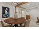 Round dining table with six chairs, a large vase, and statement artwork at 1860 Linden Rd, Winter Park, FL 32792