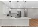 Modern kitchen with white cabinets and island at 2740 Iris Rd, Deland, FL 32724