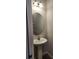 Powder room with pedestal sink and oval mirror at 3509 Yarian Dr, Haines City, FL 33844
