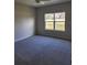 Spacious bedroom with neutral carpeting and large window at 3509 Yarian Dr, Haines City, FL 33844