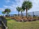 Landscaped grounds with palm trees and black metal fence at 3509 Yarian Dr, Haines City, FL 33844