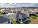 Aerial view of a house with gray roof and screened porch at 4314 Pezzullo Cir, The Villages, FL 32163