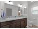 Modern bathroom with double sinks, granite countertop, and updated fixtures at 4314 Pezzullo Cir, The Villages, FL 32163