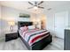 Bedroom with a queen bed, ceiling fan, and en-suite bathroom at 440 Burnham Cir, Auburndale, FL 33823