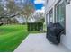 Covered patio with grill and view of grassy backyard at 664 Benoi Dr, Davenport, FL 33896
