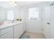 Bright bathroom with white cabinets and a large mirror at 664 Benoi Dr, Davenport, FL 33896