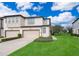 Two-story townhome with a two-car garage and front yard at 664 Benoi Dr, Davenport, FL 33896