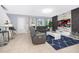 Open living room with gray sofas and a statement wall at 664 Benoi Dr, Davenport, FL 33896
