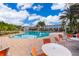 Expansive community pool with seating at 664 Benoi Dr, Davenport, FL 33896