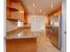 Kitchen with granite countertops, wood cabinets and stainless steel appliances at 6928 Sugarbush Dr, Orlando, FL 32819