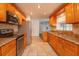 Bright kitchen features granite countertops, stainless steel appliances, and wood cabinets at 6928 Sugarbush Dr, Orlando, FL 32819