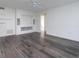 Spacious living room with grey wood-look vinyl flooring and built-in shelving at 6928 Sugarbush Dr, Orlando, FL 32819