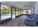 Screened patio with tiled floor, seating, and pool view at 6928 Sugarbush Dr, Orlando, FL 32819