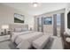 Main bedroom with plush bedding and large windows at 7517 Laureate Blvd # 4205, Orlando, FL 32827