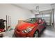 Garage with red car, golf clubs, and cleaning supplies at 7517 Laureate Blvd # 4205, Orlando, FL 32827