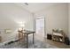 Bright home office features a desk and chair, with access to another room at 7517 Laureate Blvd # 4205, Orlando, FL 32827
