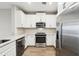 Modern kitchen with stainless steel appliances and white cabinets at 7517 Laureate Blvd # 4205, Orlando, FL 32827