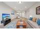 Open concept living room and kitchen with hardwood floors and modern furnishings at 7517 Laureate Blvd # 4205, Orlando, FL 32827