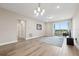 Bright living room with tile floors, balcony access, and modern lighting at 7517 Laureate Blvd # 4205, Orlando, FL 32827