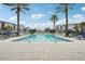 Community pool with plenty of lounge chairs for relaxing at 7517 Laureate Blvd # 4205, Orlando, FL 32827