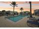 Inviting resort-style pool with lounge chairs and palm trees at 7517 Laureate Blvd # 4205, Orlando, FL 32827