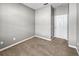 Empty bedroom with carpet, door, and neutral walls at 9143 Sw 65Th Loop, Ocala, FL 34481