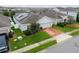 One-story house with solar panels, brick driveway, and well-maintained lawn at 975 Benjamin Trl, Davenport, FL 33837