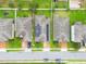 Aerial view of homes with solar panels and green yards at 975 Benjamin Trl, Davenport, FL 33837