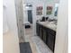 Main bathroom with double vanity, and a view into the bedroom at 975 Benjamin Trl, Davenport, FL 33837