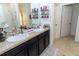 Bathroom boasts double sinks, granite countertops, and a walk-in shower at 975 Benjamin Trl, Davenport, FL 33837