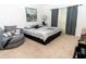 Spacious bedroom with large bed, plush seating, and neutral decor at 975 Benjamin Trl, Davenport, FL 33837