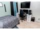 Bright bedroom with a comfortable bed, workspace, and large TV at 975 Benjamin Trl, Davenport, FL 33837