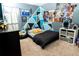 Bright bedroom with a full-size bed and a geometric wall design at 975 Benjamin Trl, Davenport, FL 33837