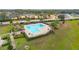 Community pool and clubhouse with surrounding landscape at 975 Benjamin Trl, Davenport, FL 33837