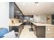 Spacious kitchen featuring dark cabinetry and stainless steel appliances at 975 Benjamin Trl, Davenport, FL 33837